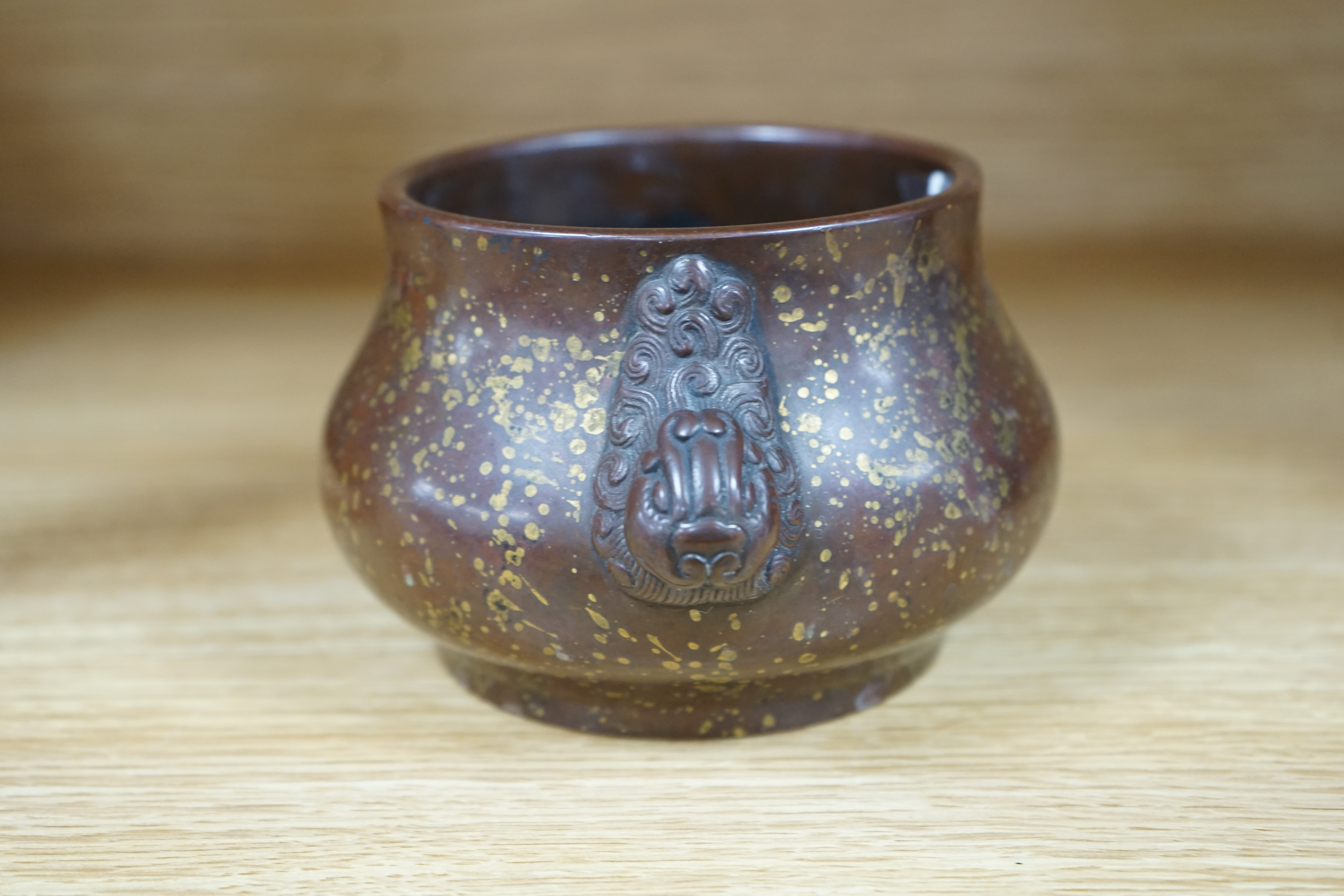 A Chinese gold splashed bronze censer, gui, four character mark, 9cm high. Condition - good